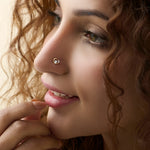 Open heart diamond nose stud worn by a smiling woman, close-up beauty shot