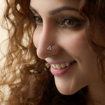Woman wearing fancy gold triangle nose pin close-up portrait