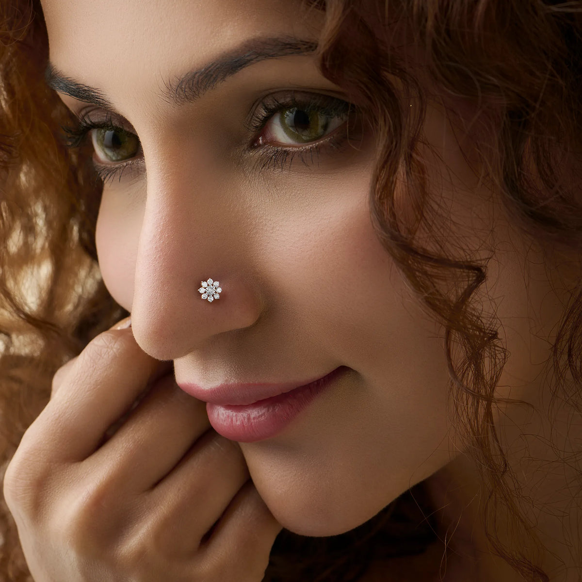 Close-up of woman wearing a nose stud with an oval multi-diamond cluster