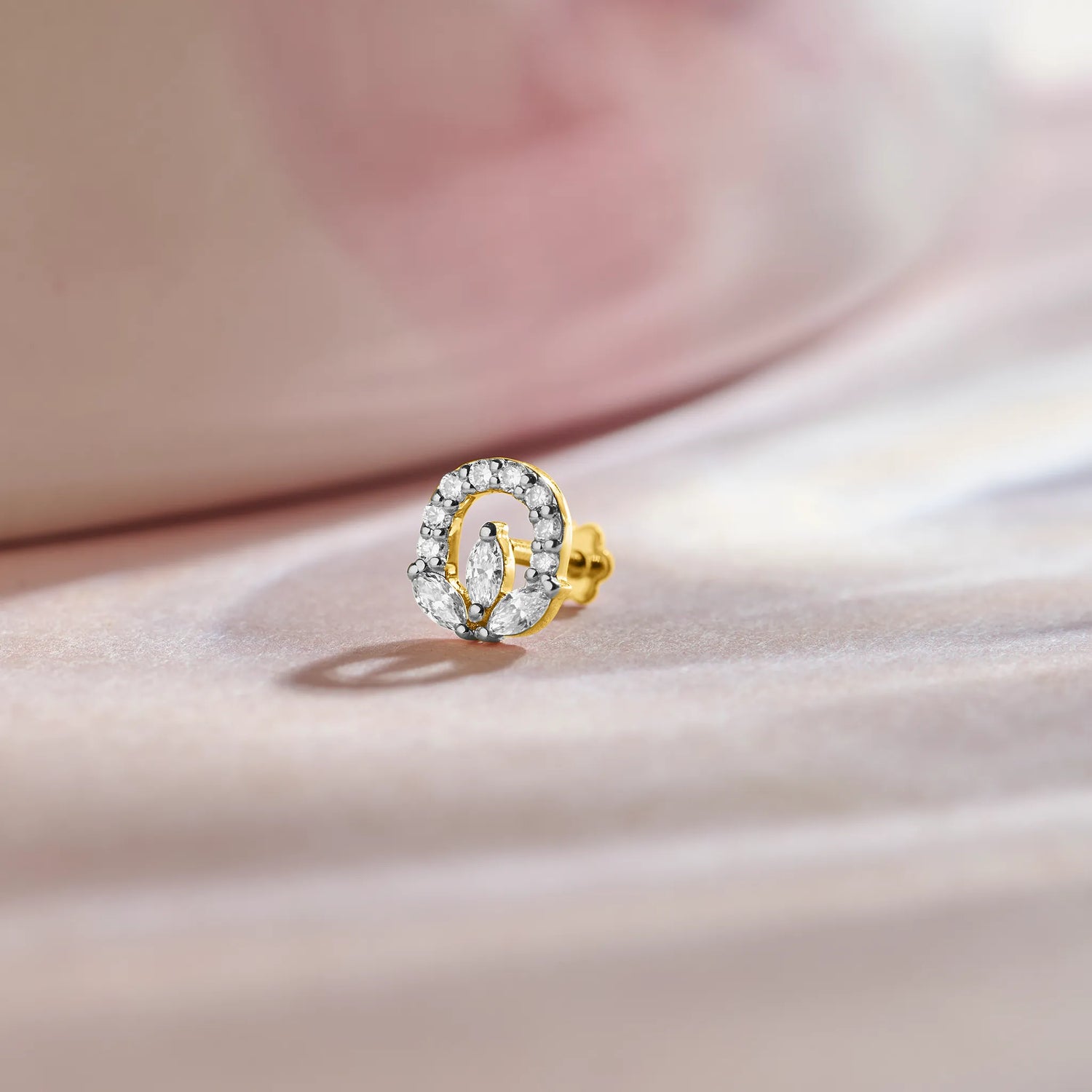 Oval halo lab grown diamond nose pin with center stone on soft pink background