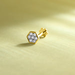 Gold hexagon diamond nose pin on soft pastel background