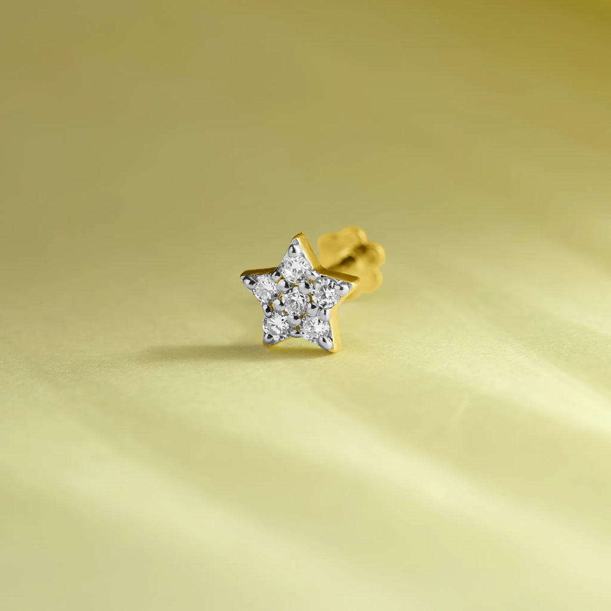 14k gold star-shaped stud earring featuring multiple round diamonds