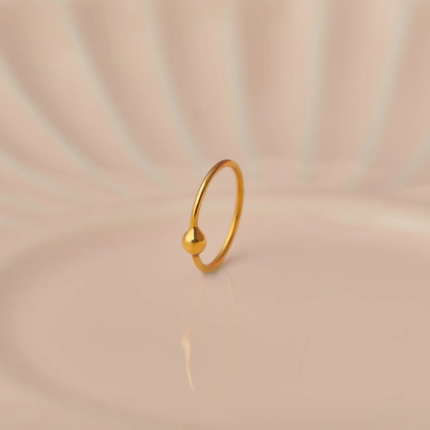 Plain gold hoop earring with small ball closure