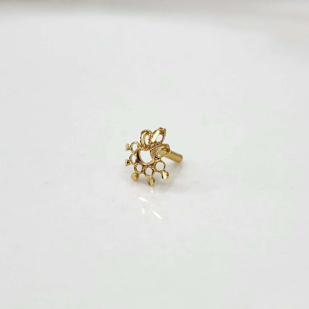 Product shot of a plain gold nose stud with filigree flower design