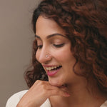 Nose pin gold worn on the nose in a close-up portrait, showcasing a delicate and elegant everyday jewelry style