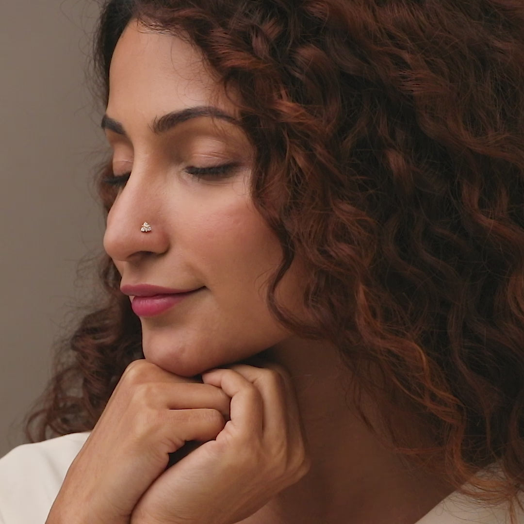 Nose pin gold worn on the nose in a close-up portrait, showcasing a modern and elegant everyday jewelry look