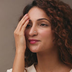 Nose pin gold worn on the nose in a close-up portrait, showcasing a classic and elegant everyday jewelry look