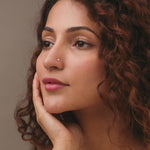 Woman wearing elegant Kerala style gold diamond nose pin portrait