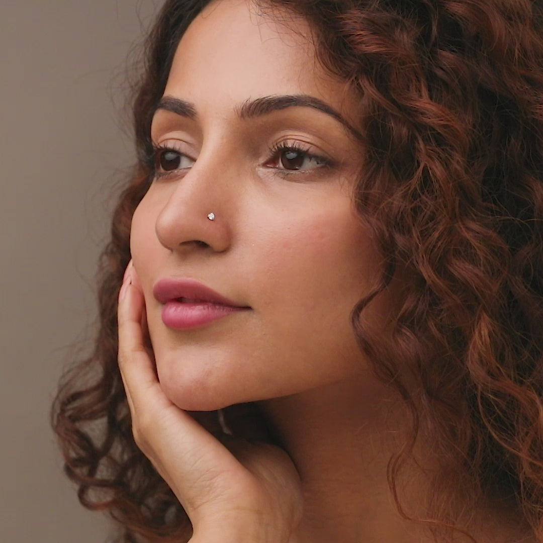 Woman wearing elegant Kerala style gold diamond nose pin portrait