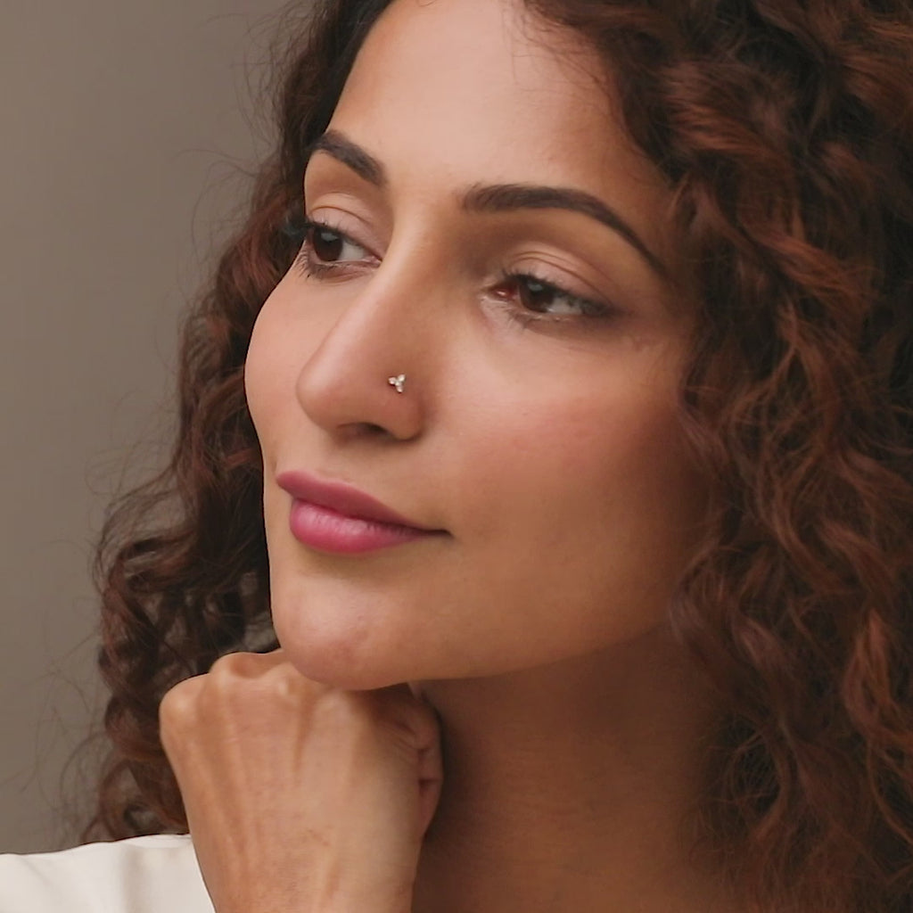 Nose pin gold worn on the nose in a close-up portrait, highlighting a subtle and elegant everyday jewelry style