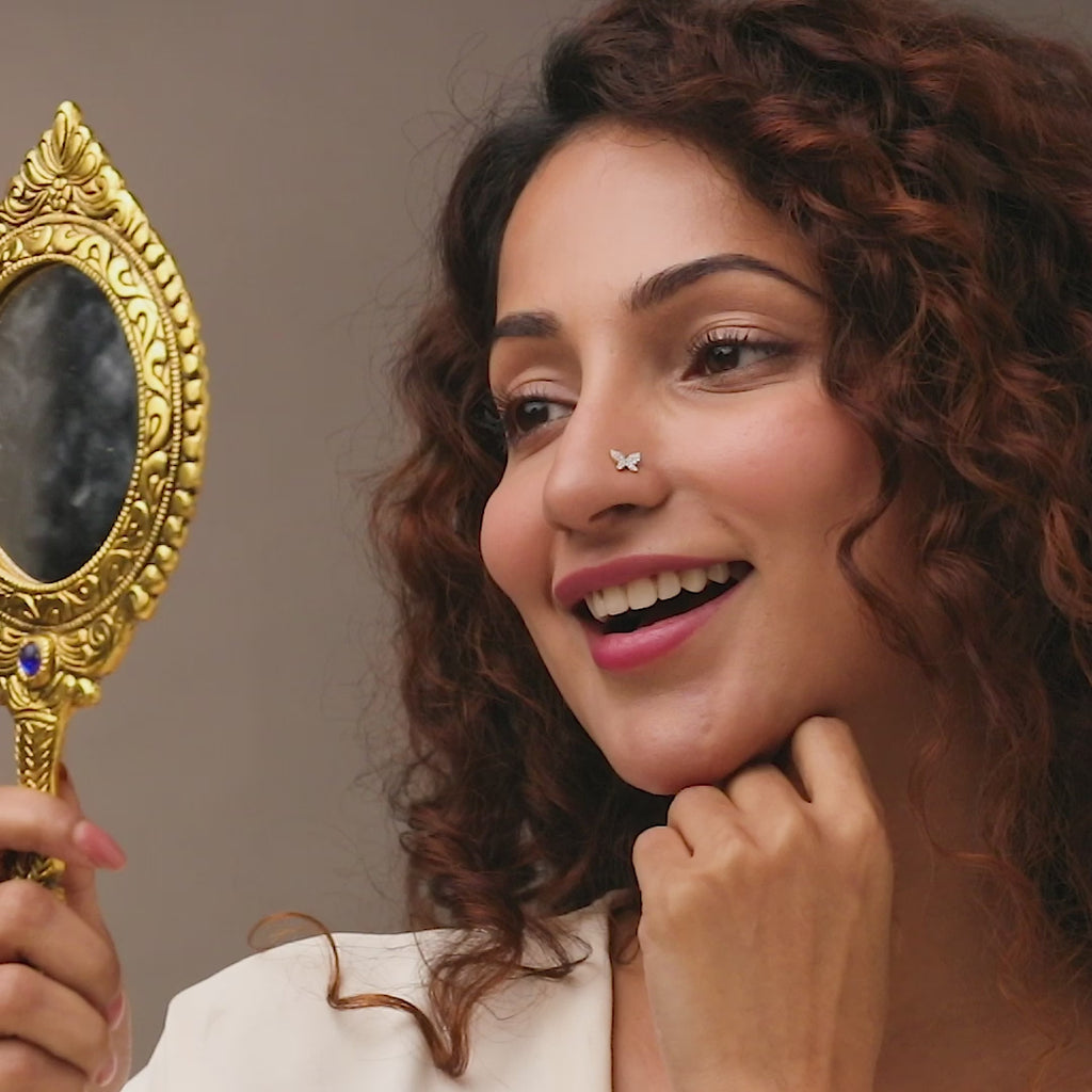Stone Gold Nose Pin worn on the nose in a close-up portrait, showcasing a trendy and elegant butterfly style nose accessory