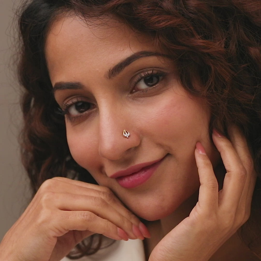 Trending nose pin gold worn on the nose in a close-up portrait, highlighting a modern and stylish everyday jewelry look