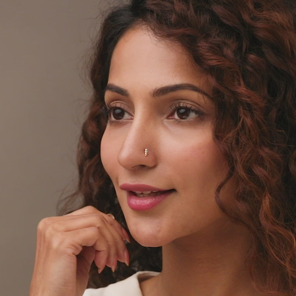 Nose pin gold worn on the nose in a close-up portrait, showcasing a minimal and elegant everyday jewelry style