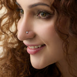Woman wearing elegant Kerala style gold diamond nose pin close-up portrait