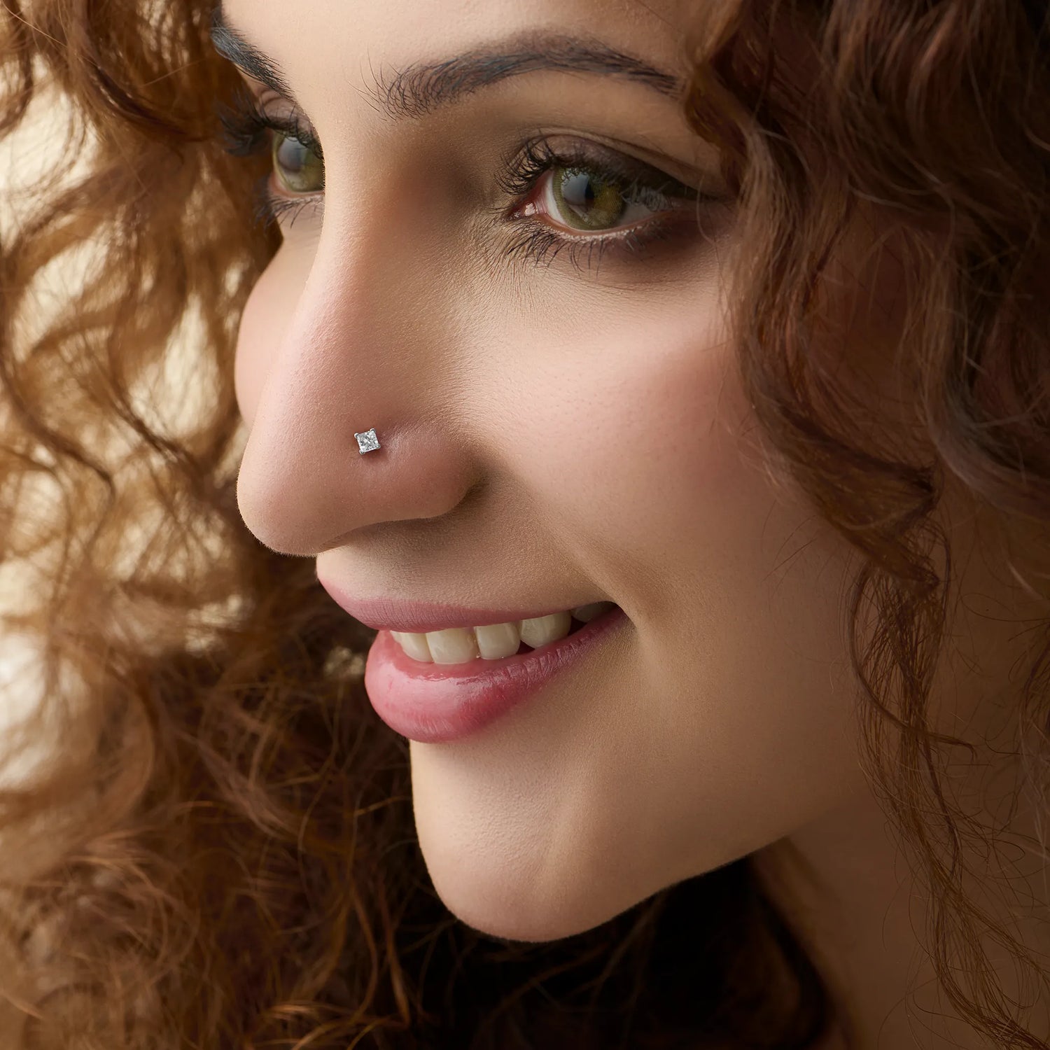 Woman wearing elegant Kerala style gold diamond nose pin close-up portrait