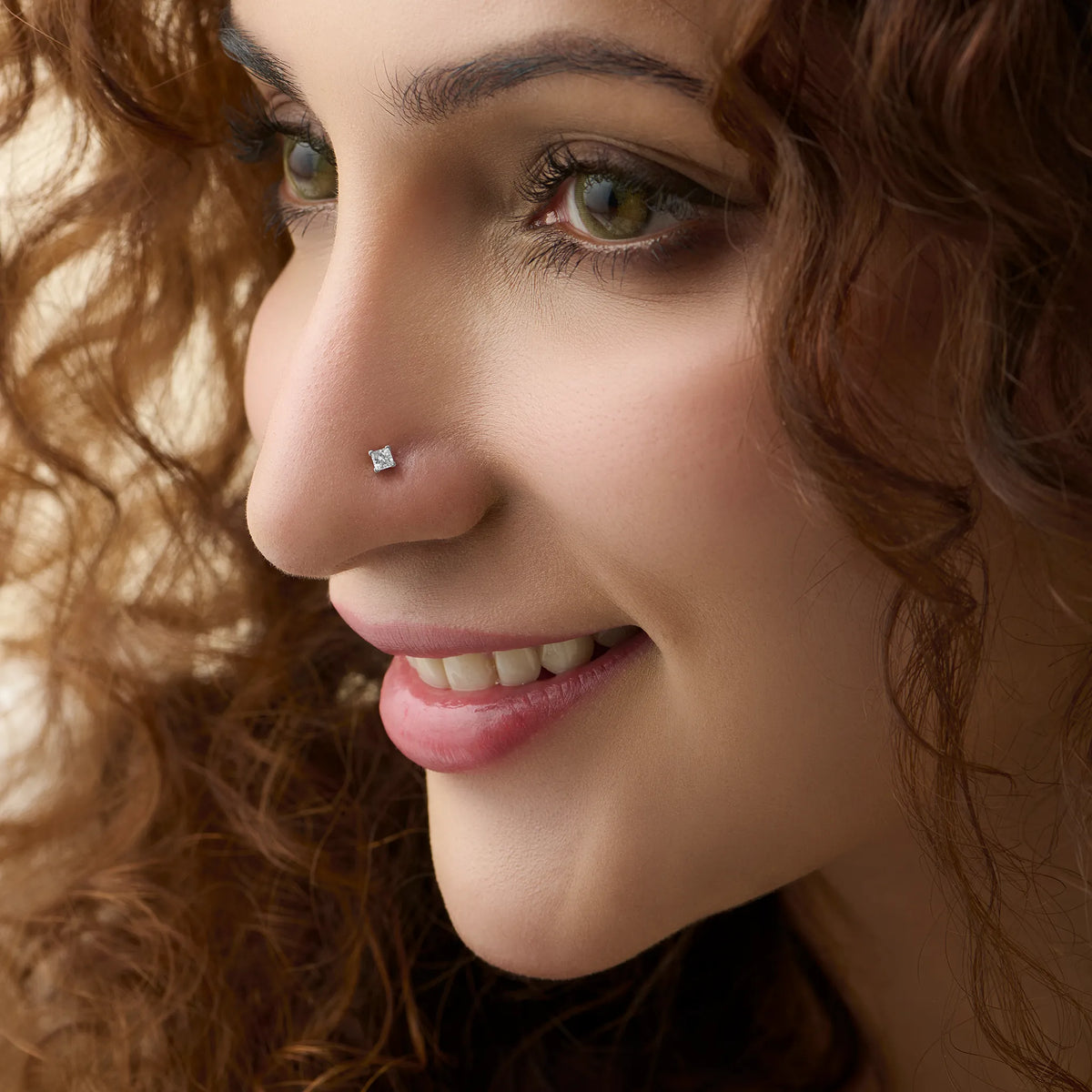 Woman wearing elegant Kerala style gold diamond nose pin close-up portrait