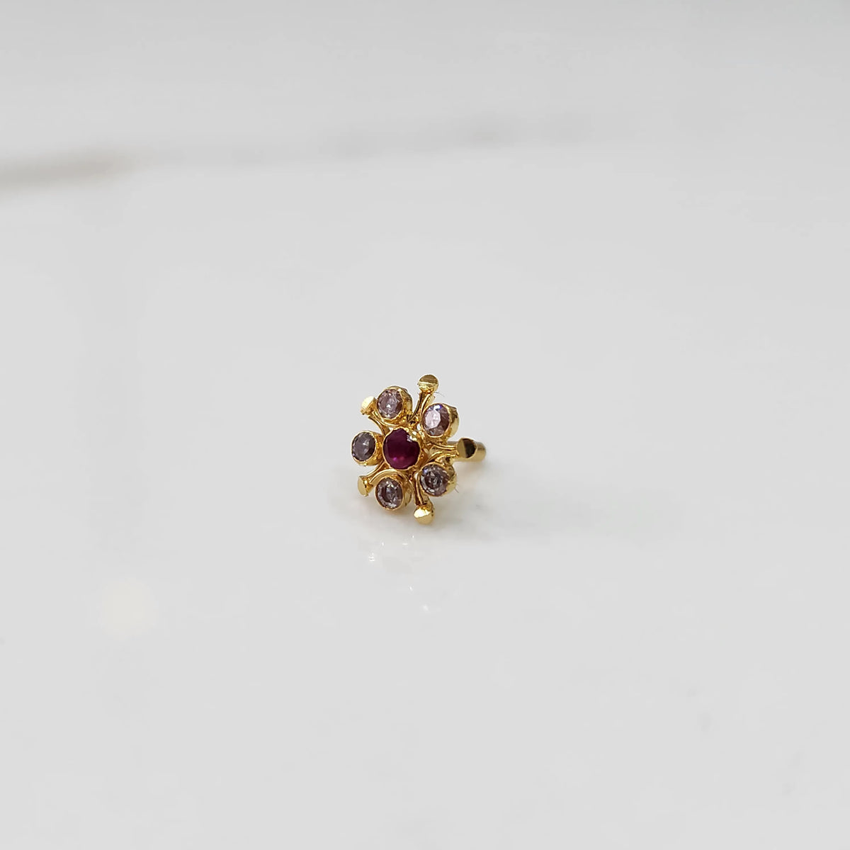 Gold floral nose pin with red and purple stones
