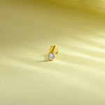 Simple gold nose pin design product image on soft pastel background