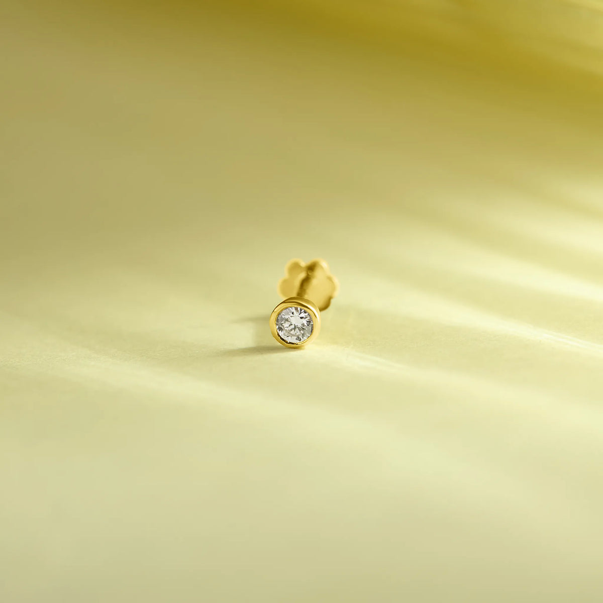 Simple gold nose pin design product image on soft pastel background