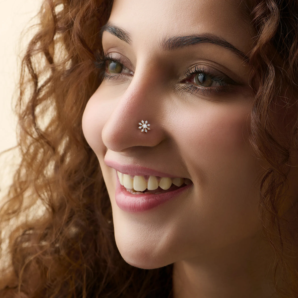 Model showcasing a delicate full-round blossom diamond nose pin