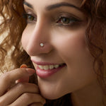 Woman wearing elegant gold diamond nose pin close-up portrait