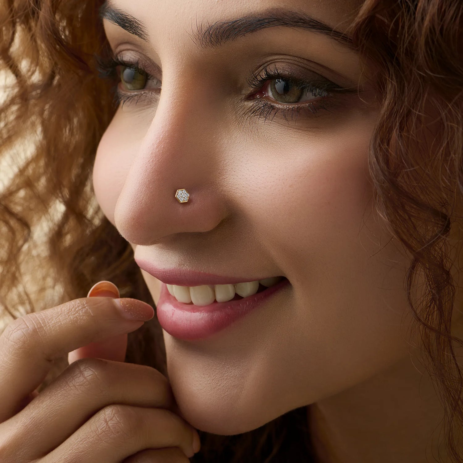 Woman wearing elegant gold diamond nose pin close-up portrait