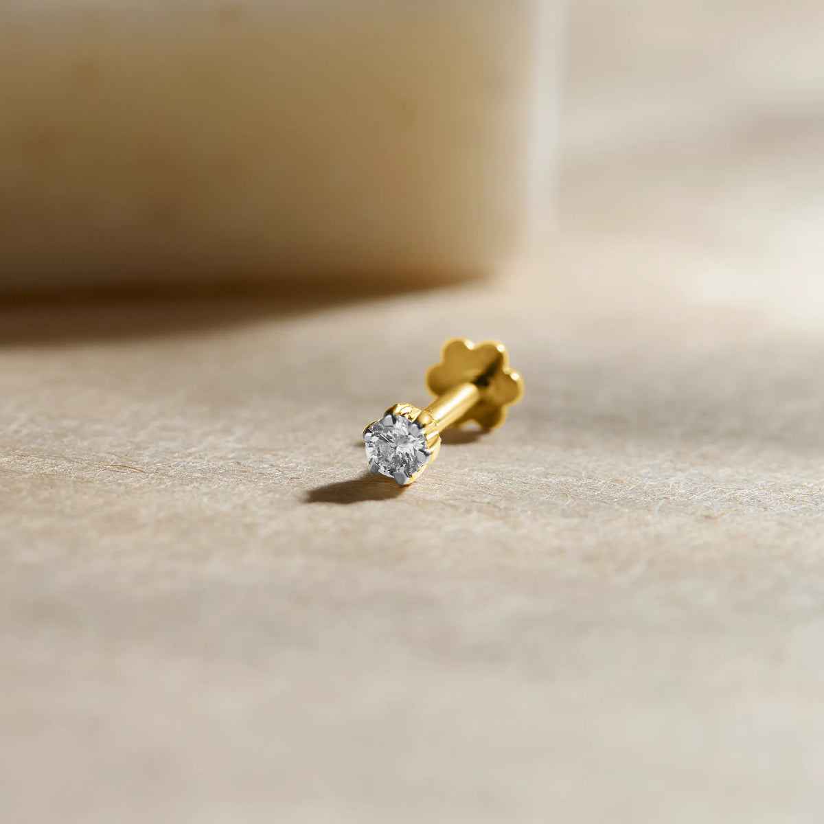 14K gold nose pin with round-cut solitaire diamond