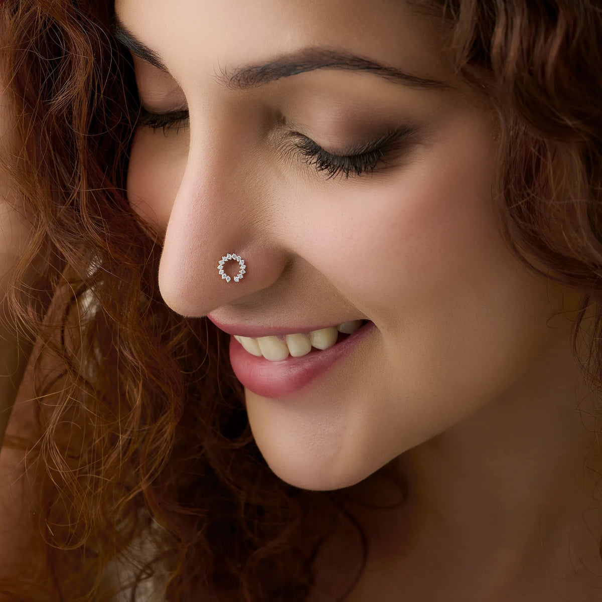 Woman wearing elegant gold circular nose pin close-up portrait