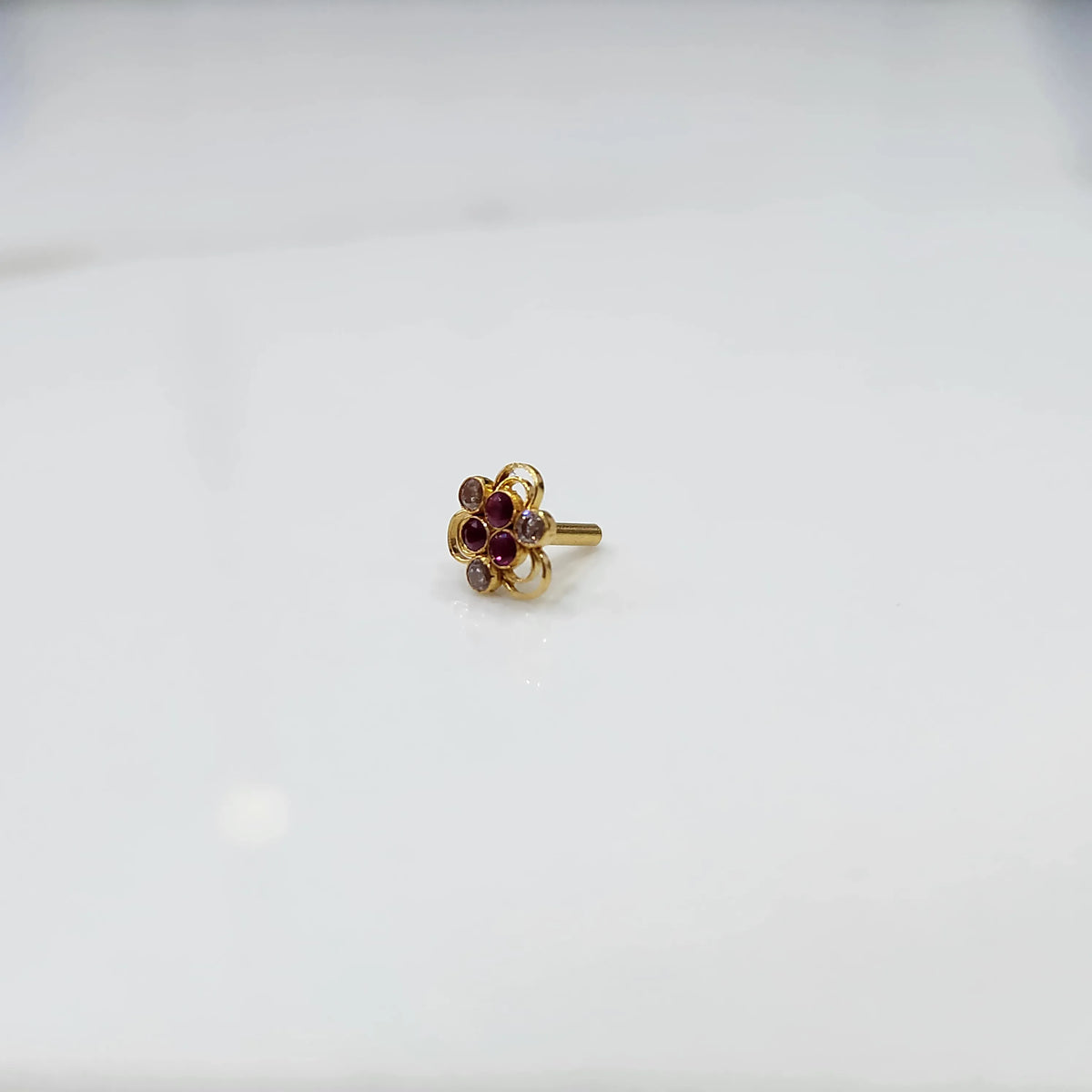 Minimal top down view of the stone nose pin emphasizing compact craftsmanship
