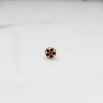 Ruby flower cluster nose stud with round gold border, jewelry photography