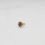 Close-up of a seven-stone multicolor gemstone nose pin in gold setting