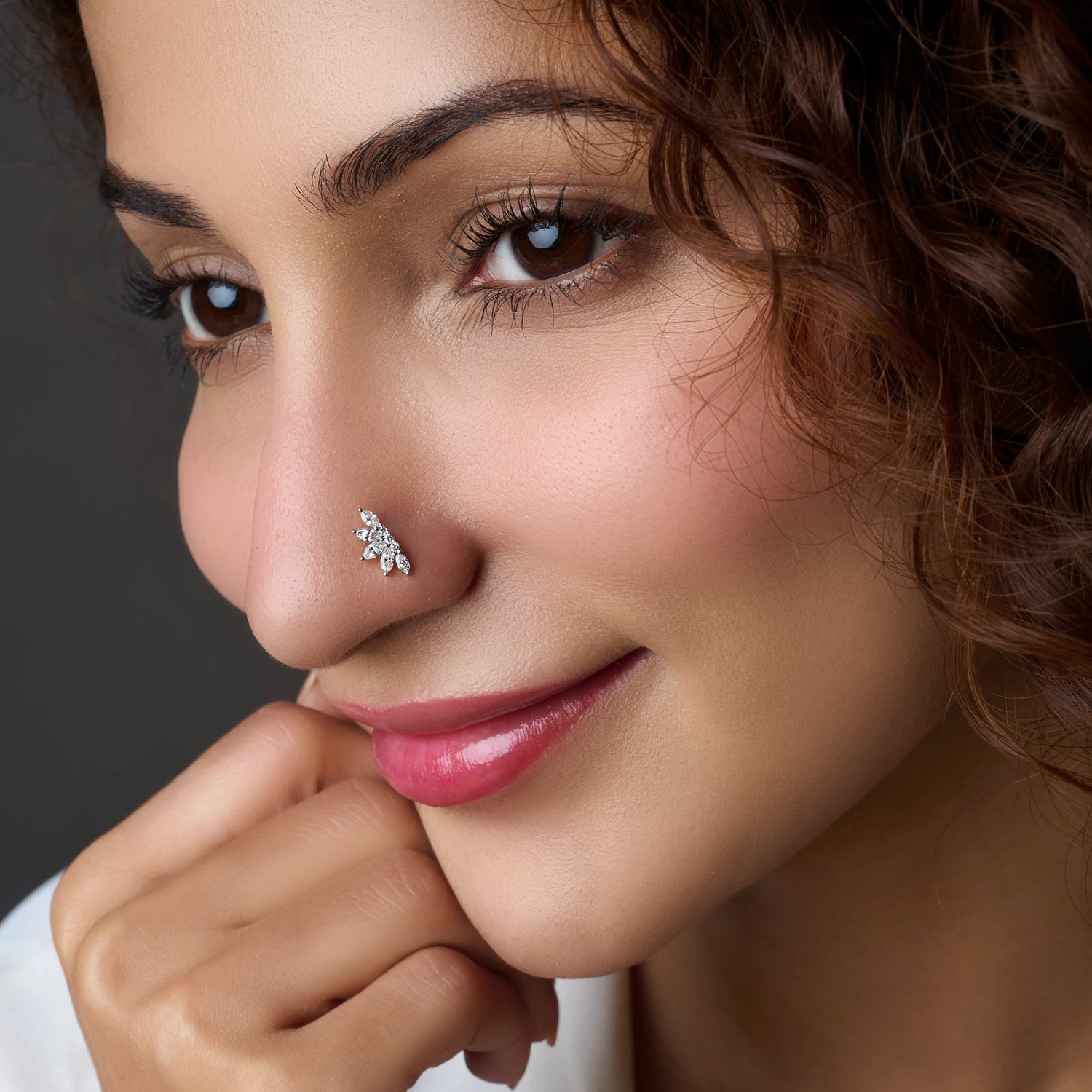 Woman wearing a cluster-style silver nose pin