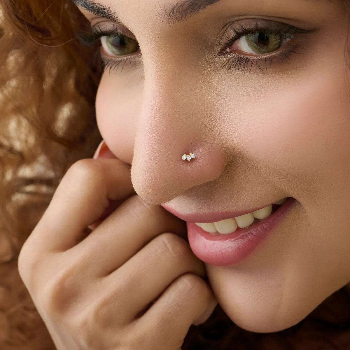Close-up of woman wearing a silver double-stone stud nose ring