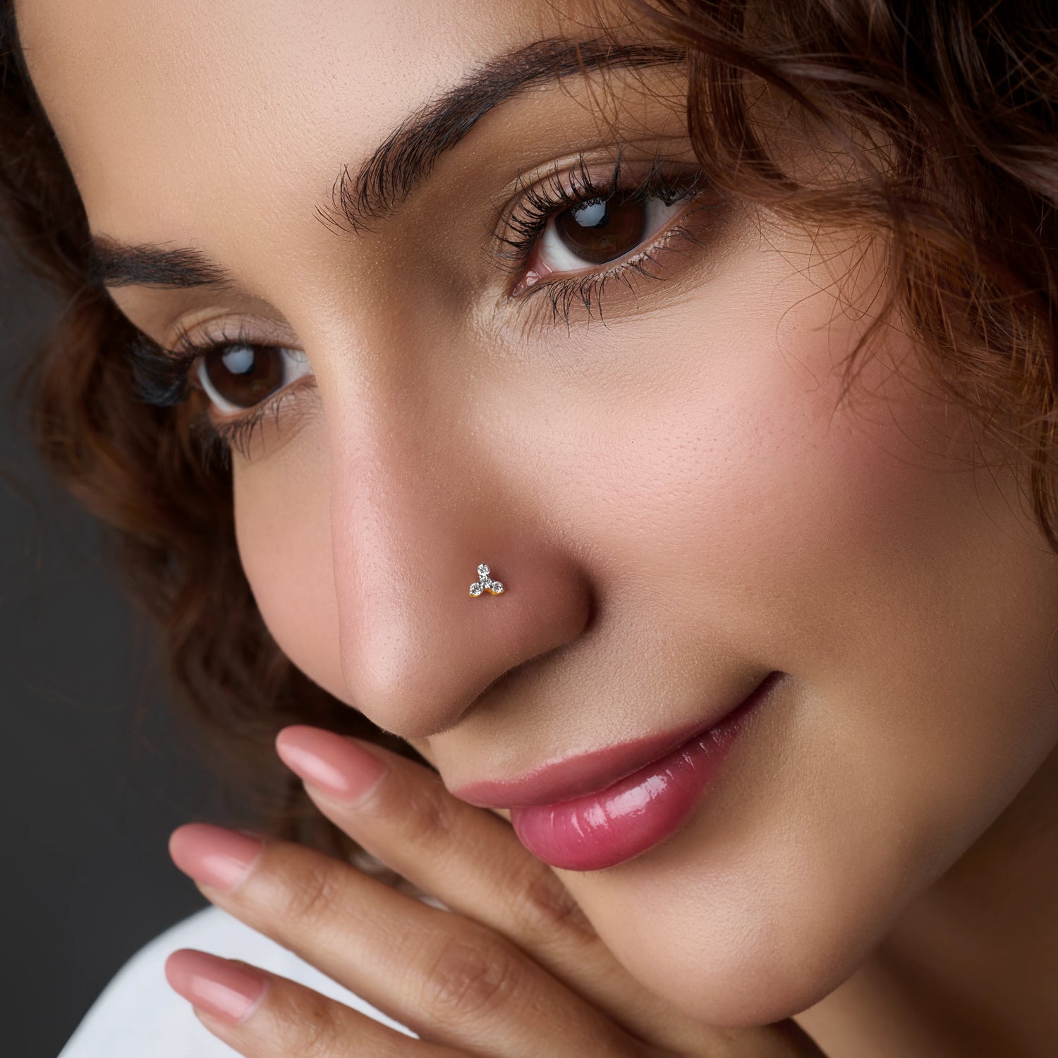 Woman wearing a small flower-shaped silver nose pin
