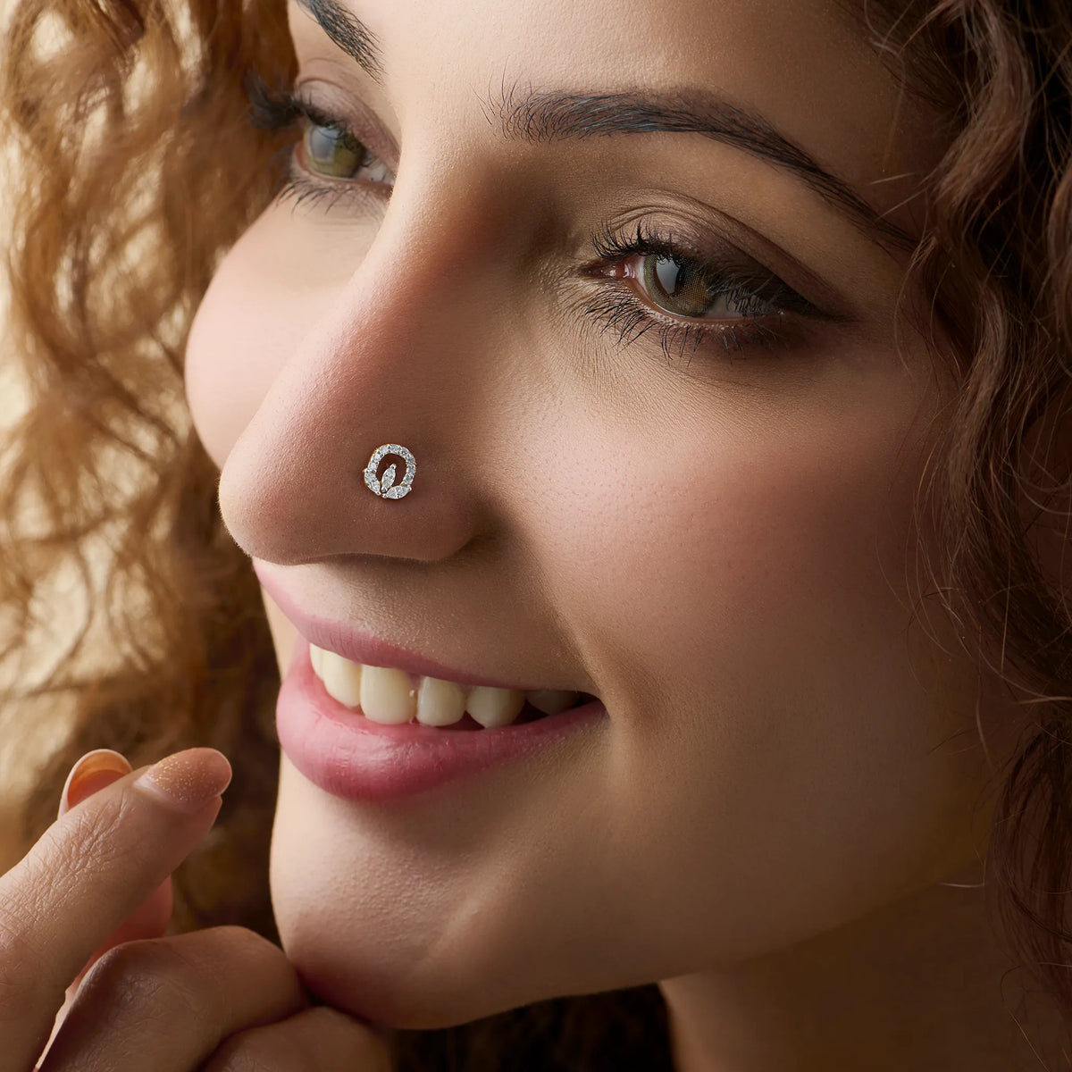 Woman wearing elegant oval lab grown diamond nose pin with sparkling halo design