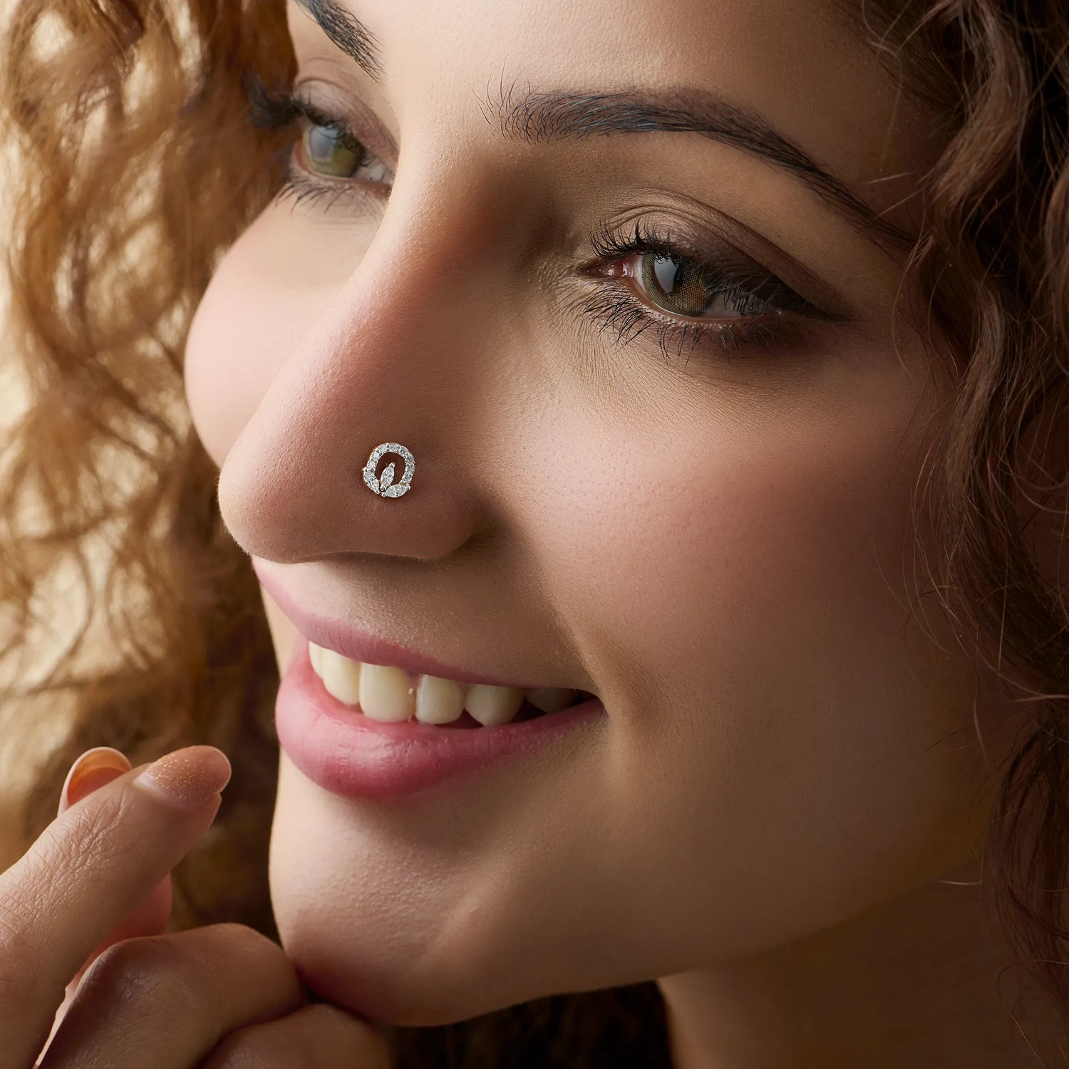 Woman wearing elegant oval lab grown diamond nose pin with sparkling halo design