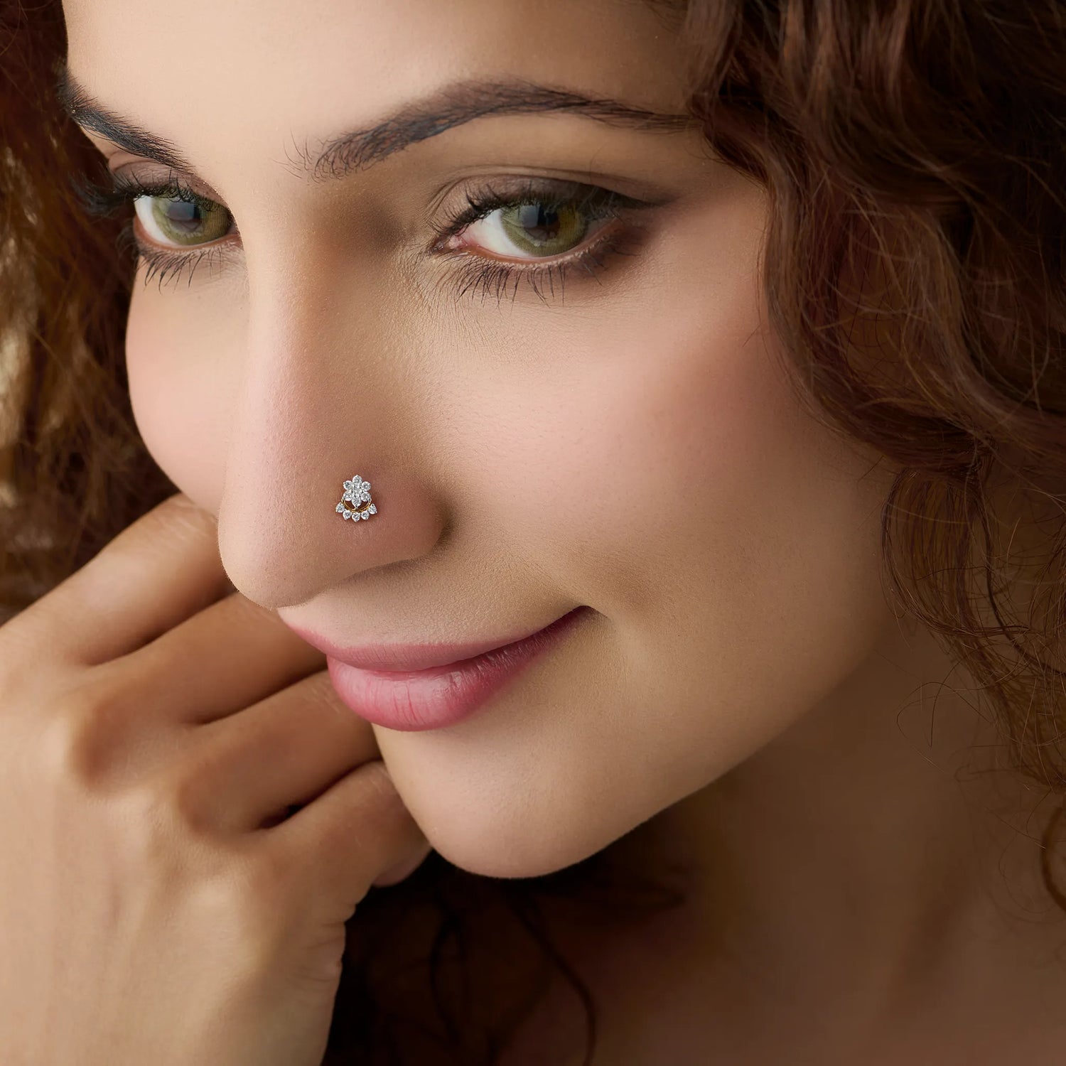 Woman wearing elegant lab grown gold nose pin with floral diamond design