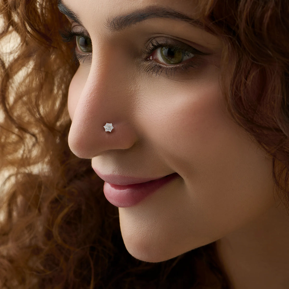 Stone Gold Nose Pin worn on the nose in a close-up side profile, showing an elegant everyday jewelry look