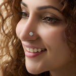 Close-up of woman wearing a silver round pavé stud nose ring