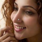 Woman wearing elegant teardrop gold nose pins with diamond shine