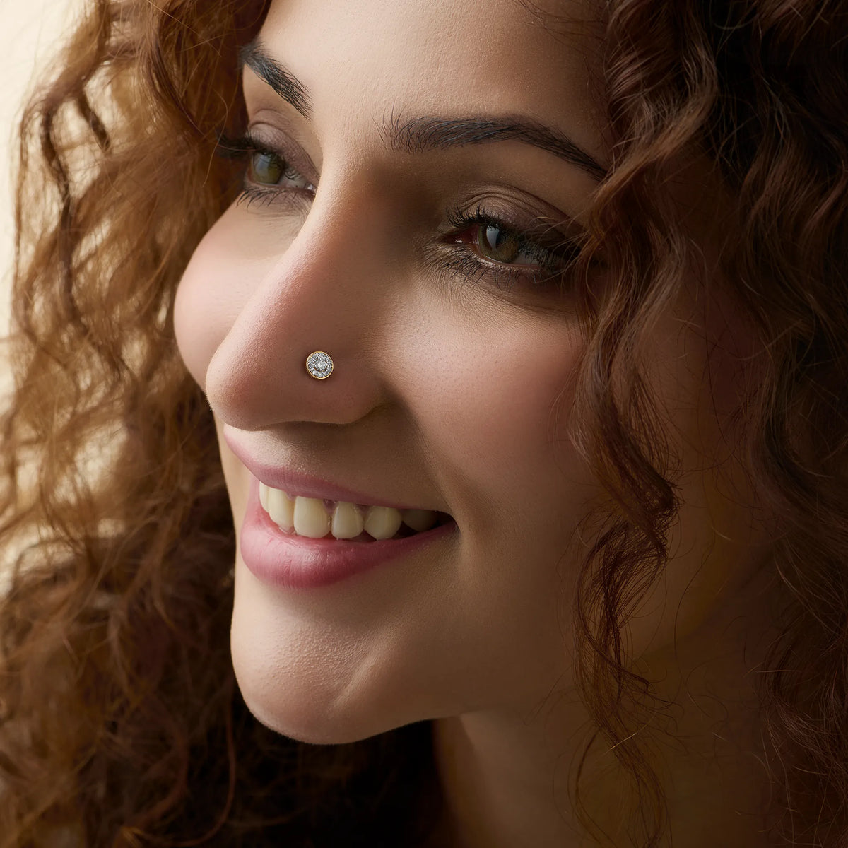Close-up of woman wearing a silver round stud nose ring, big smile