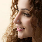 Woman wearing lab grown gold nose pin with elegant diamond floral style