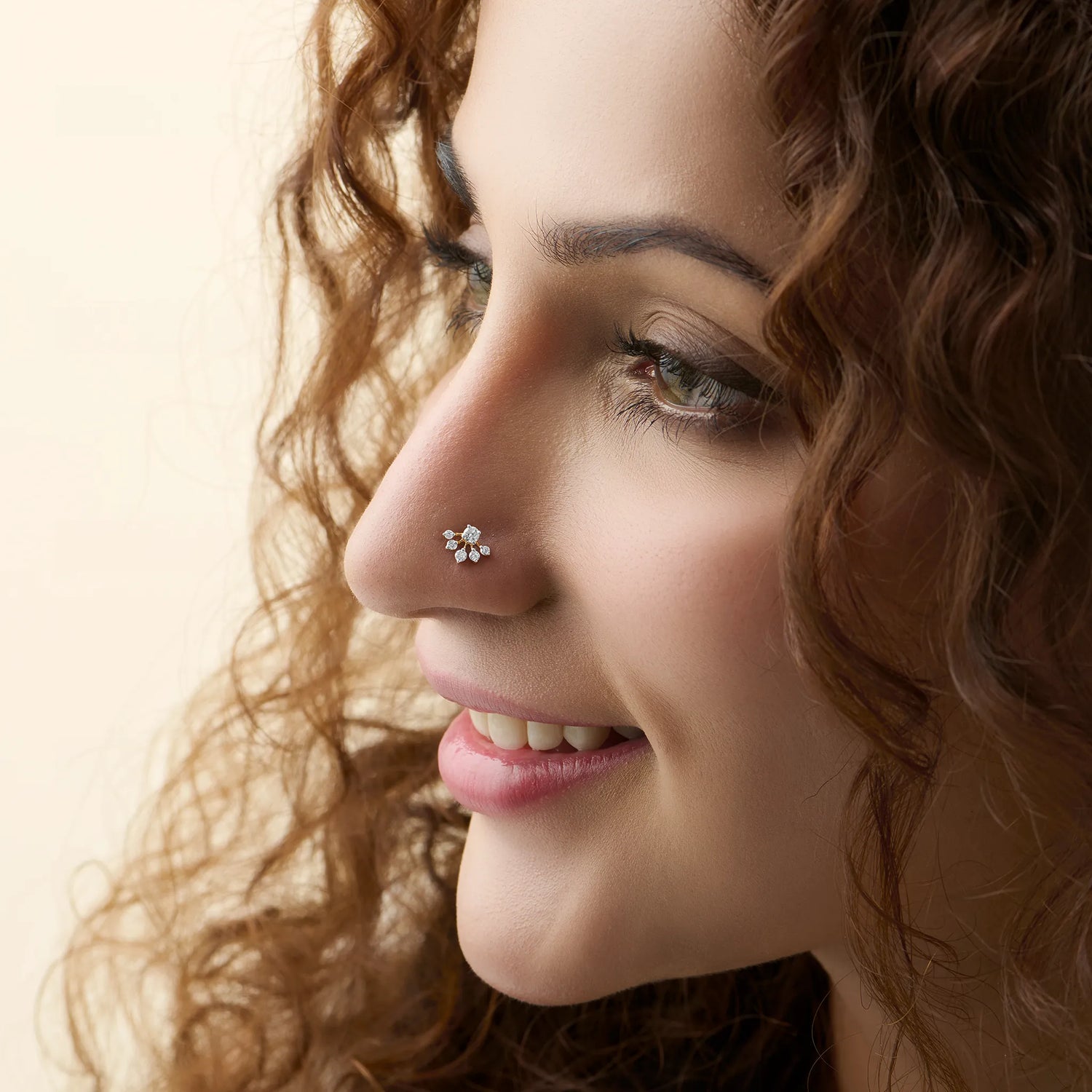 Woman wearing lab grown gold nose pin with elegant diamond floral style