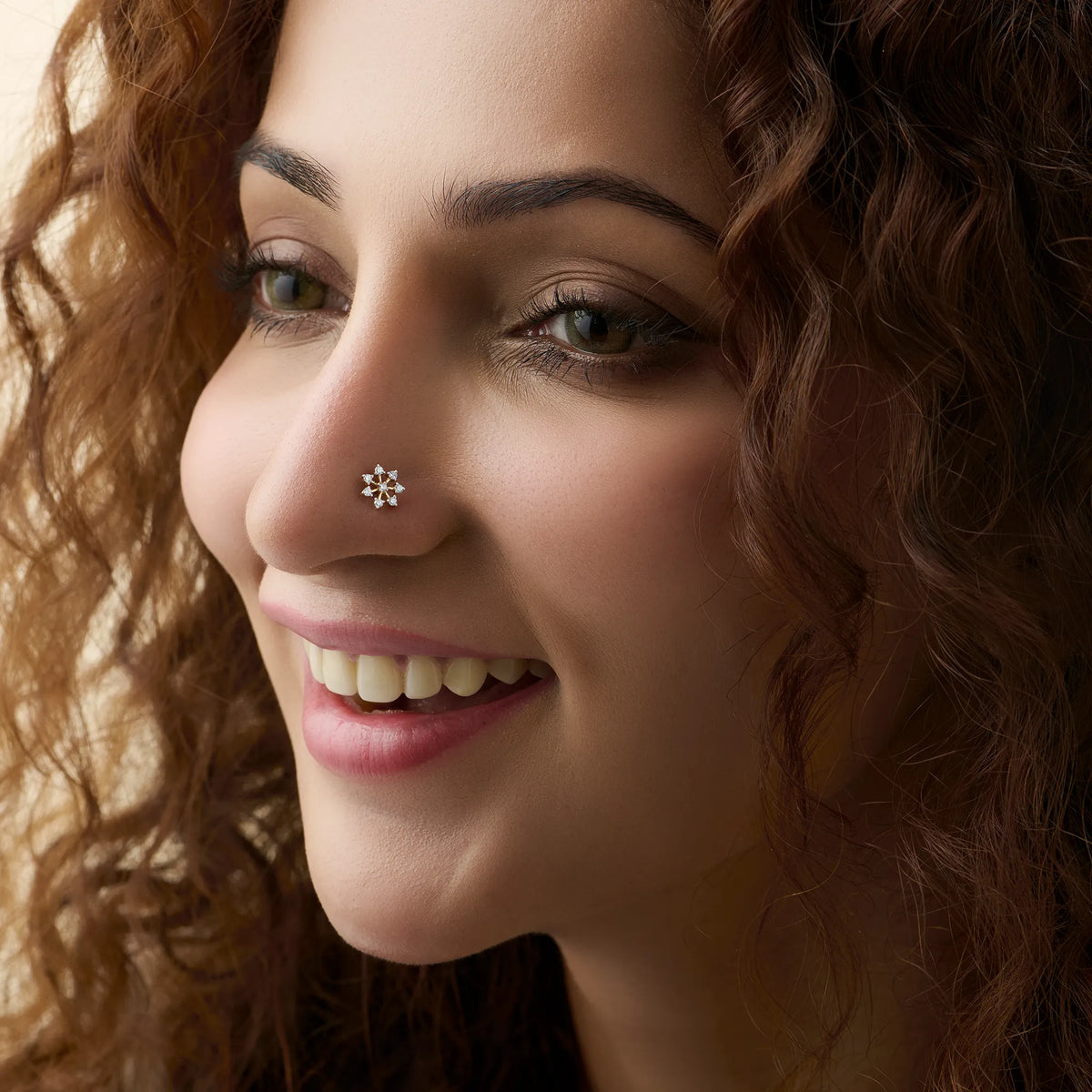 Woman wearing diamond  star shaped design 18K gold nose pin