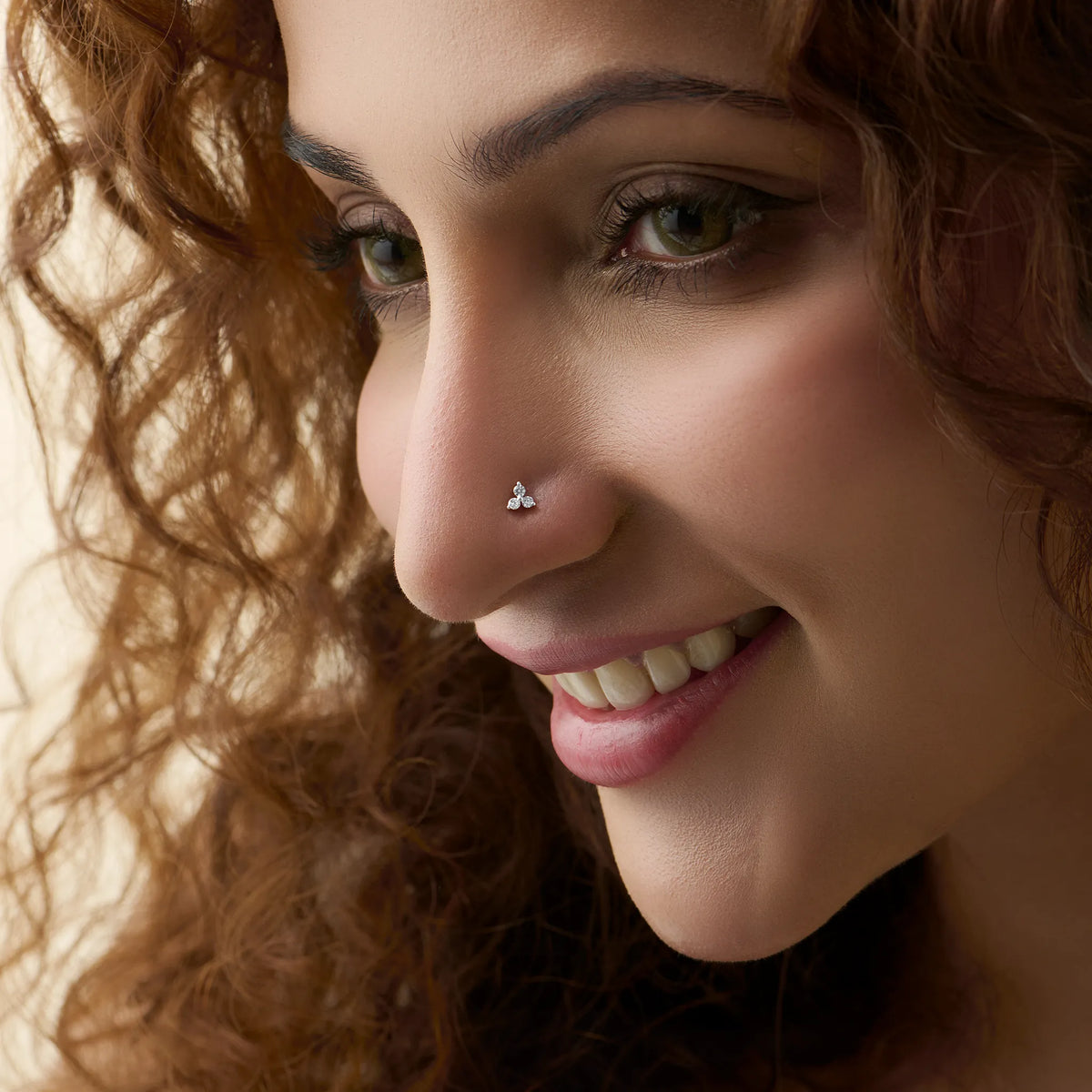 Nose pin gold design for female worn on side face preview showing elegant look