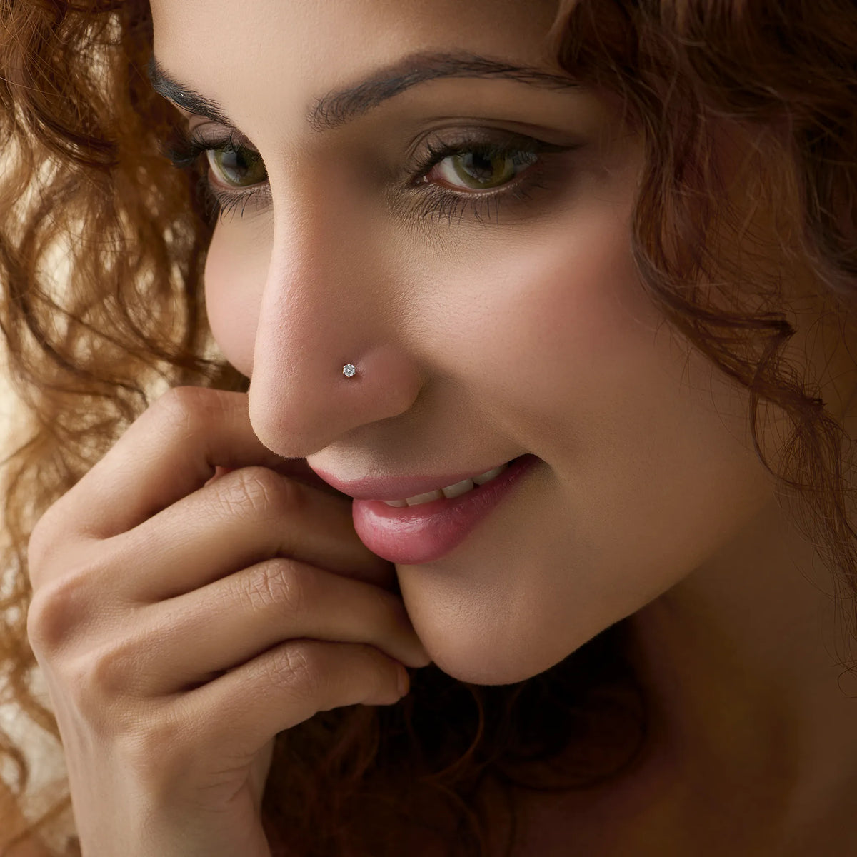Woman wearing elegant Kerala style gold diamond nose pin close-up portrait