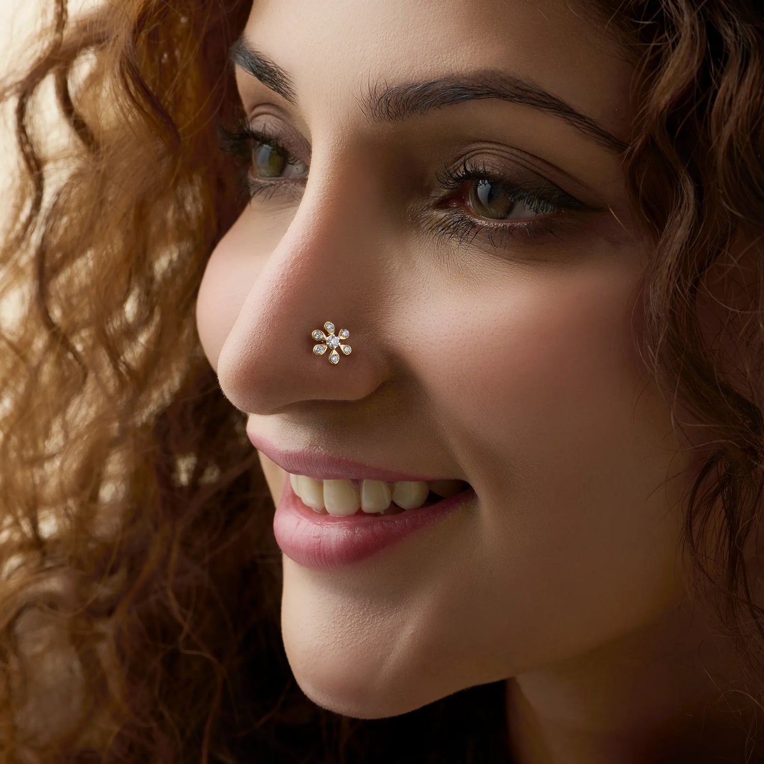 Model showcasing a delicate daisy-cluster diamond nose pin