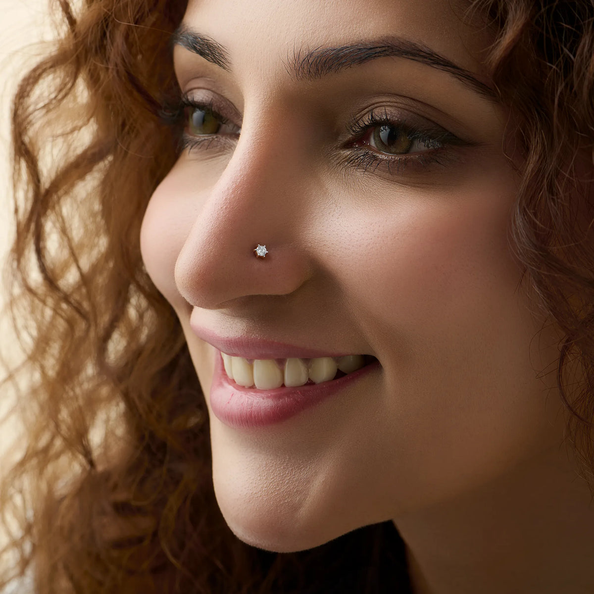 Close-up of woman wearing a nose stud with a six-prong set diamond