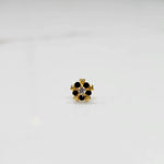 Traditional gold nose pin featuring a radiating black gemstone flower