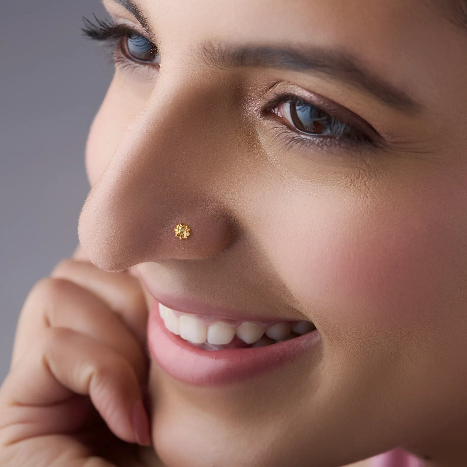 Model with minimal gold nose pin, close-up lifestyle shot